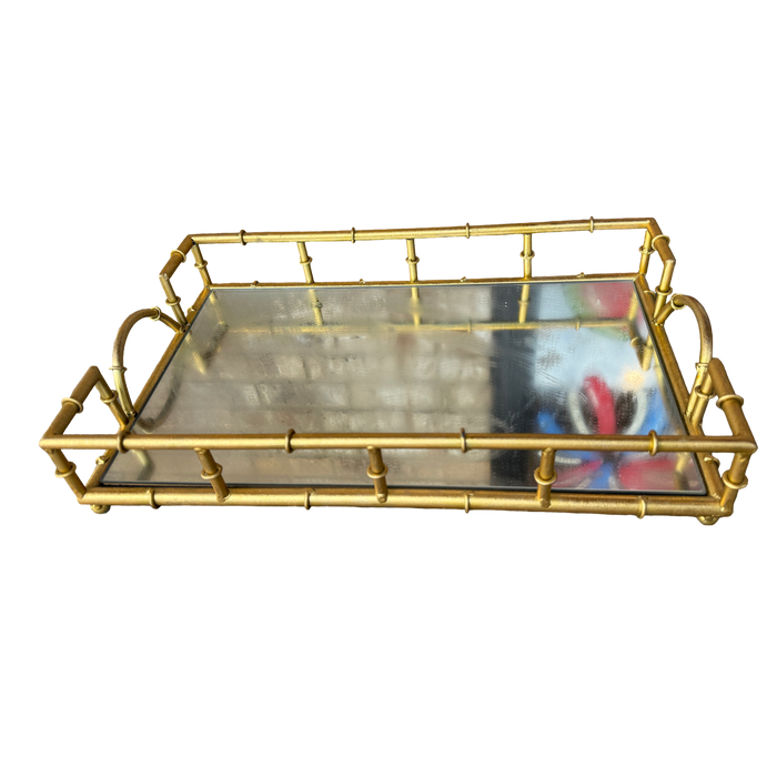 A rectangular serving tray with a gold-toned metal frame designed to look like bamboo stalks, featuring a clear glass tray insert and loop handles on the sides, shown against a plain white background.