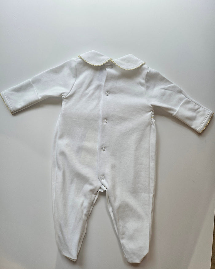 White long-sleeve top with lace details on a light gray background