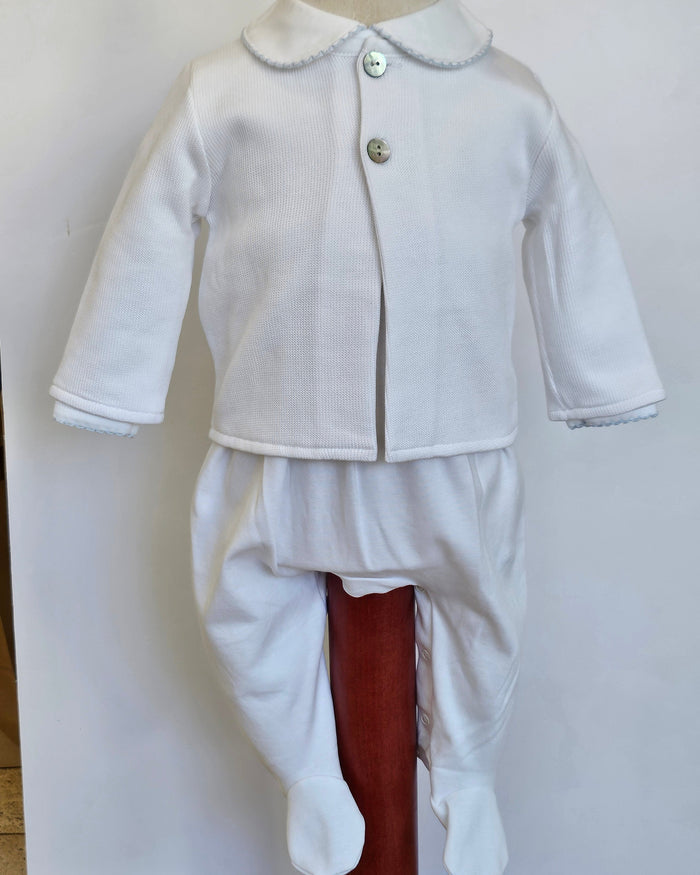 A white baby footed romper suit with a long-sleeve button-front cardigan jacket and matching pants, displayed on a mannequin against a plain white background.