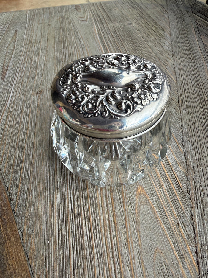 Decorative glass doorknob with silver metal base on wooden surface