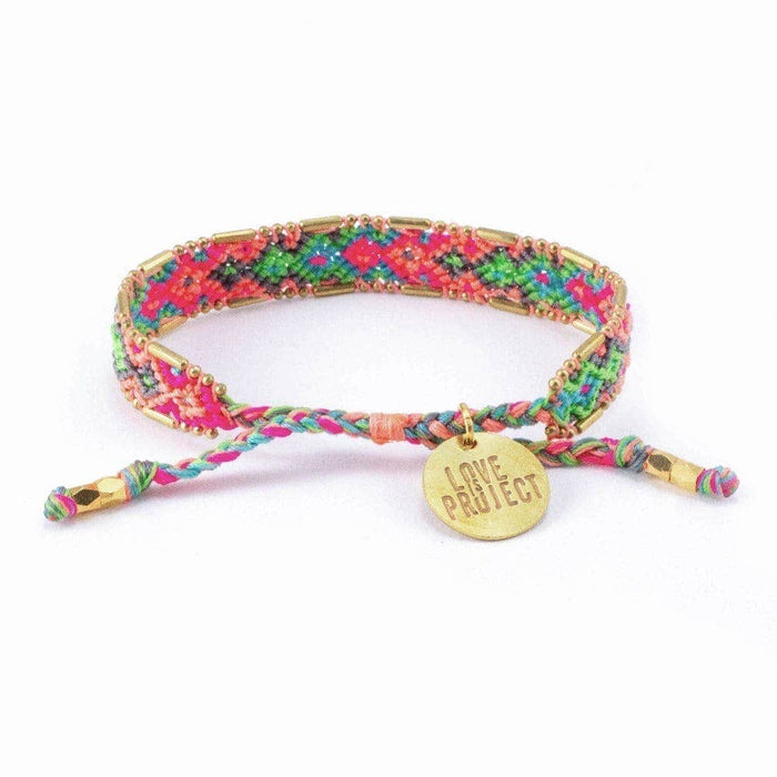 Colorful braided bracelet with a gold tag on a white background