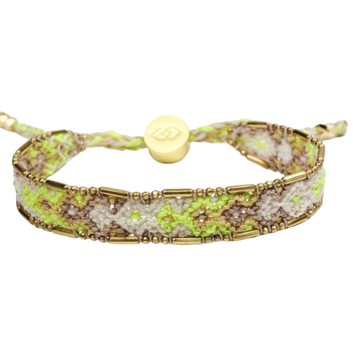 Bracelet with gold accents and green pattern on a white background