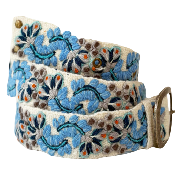 Jenny Krauss Blue Serenade hand-embroidered wool belt with intricate blue floral stitching on ivory wool and brass-tone buckle.