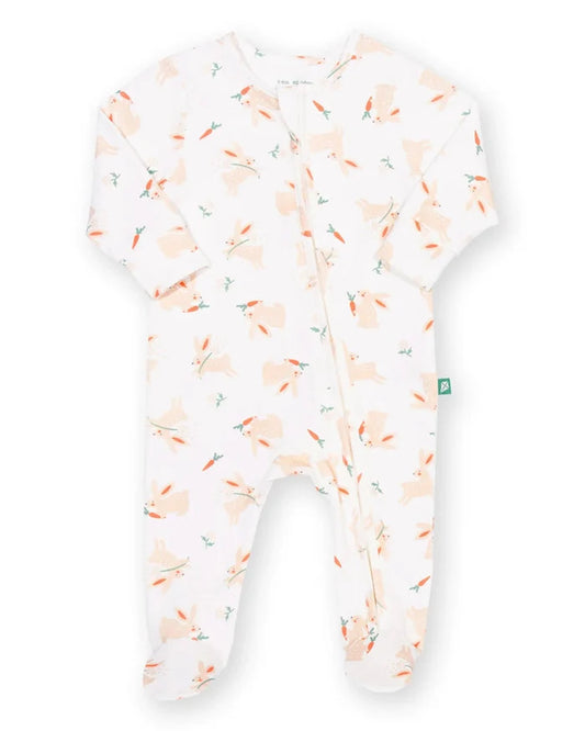 A baby footed sleeper in white with a light peach and orange bunny print, shown flat on a white background.