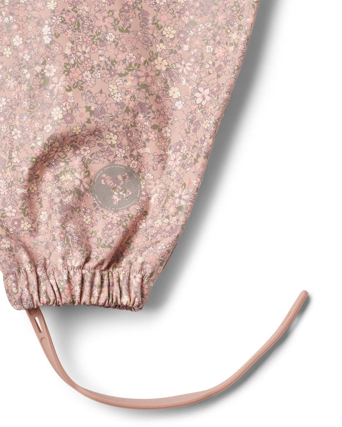 Floral patterned pink bag with a brand logo on a white background