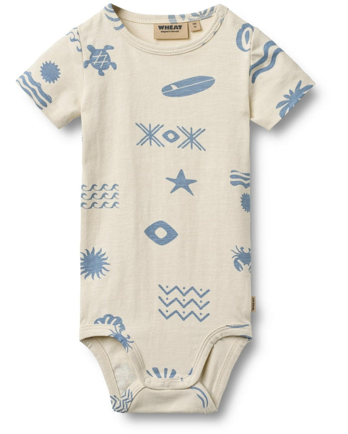Beige baby onesie with blue sea-themed patterns on a white background