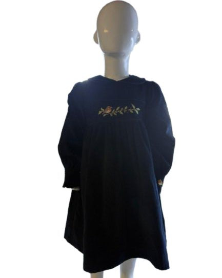 Navy blue dress with floral embroidery on a mannequin against a white background