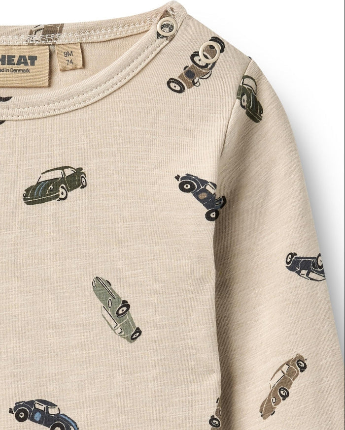 Beige long-sleeve shirt with car pattern and 'WHEAT' branding on a light gray background