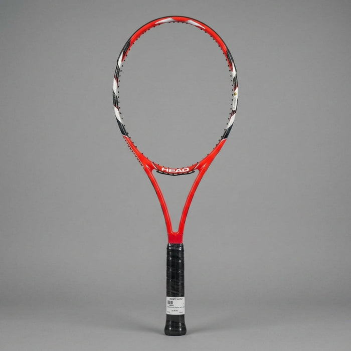A red and black HEAD tennis racket with a black wrapped grip, standing upright against a solid gray background.