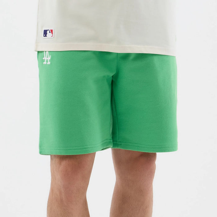 The model is wearing this MLB League Essential LA Dodgers Shorts in open green. 6