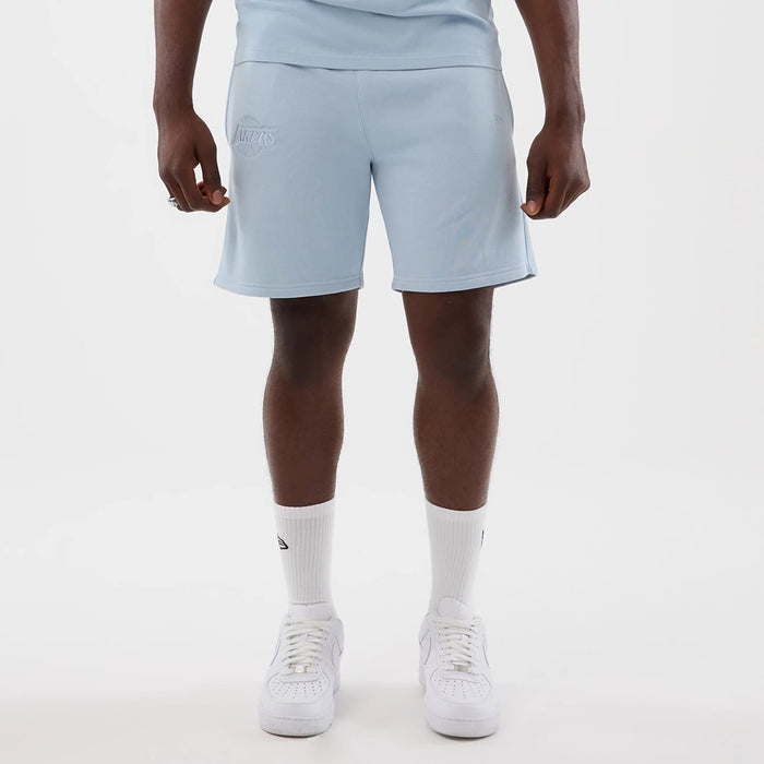 The model is wearing this NBA League Essential LA Lakers Shorts in pastel blue. 1