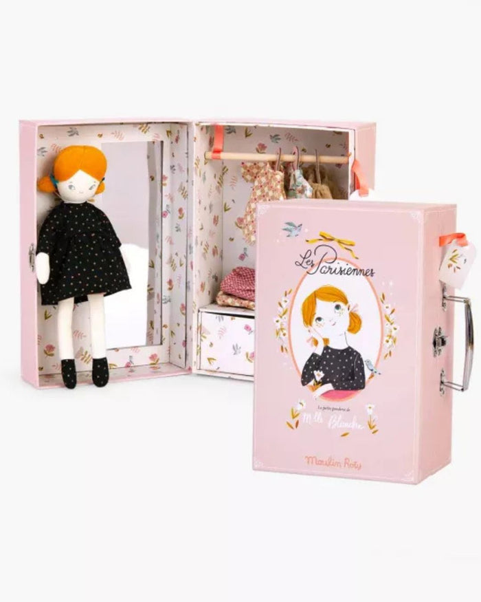 Doll with orange hair and black polka dot dress in a decorative box with 'La Parisienne' branding.