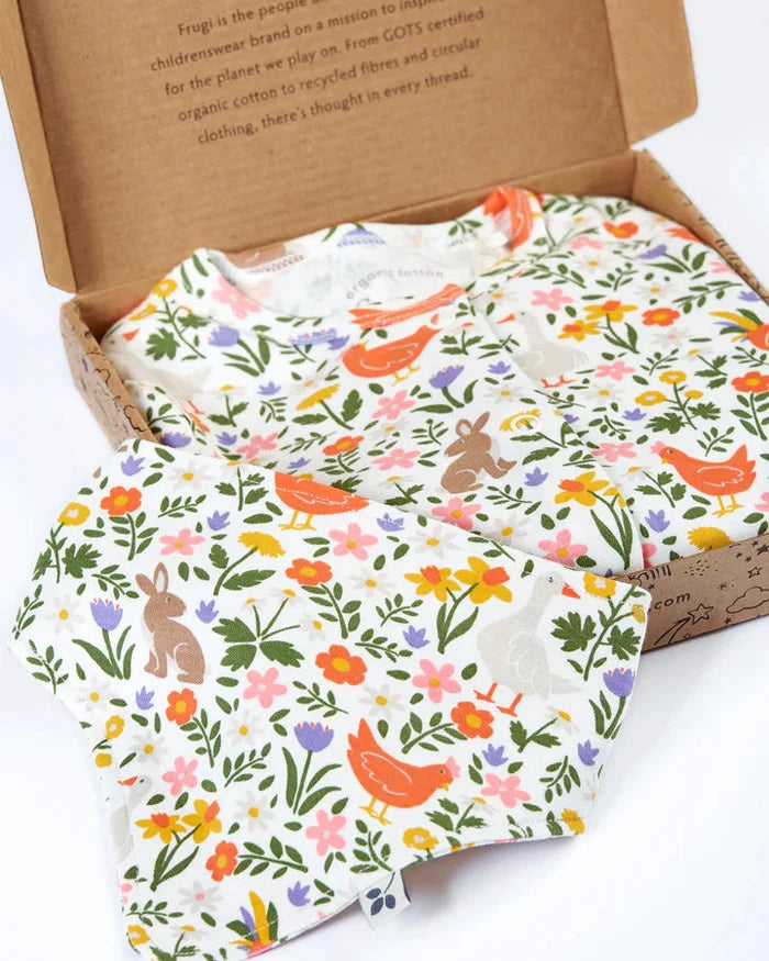 Floral and animal patterned fabric in a cardboard box with text on a white background