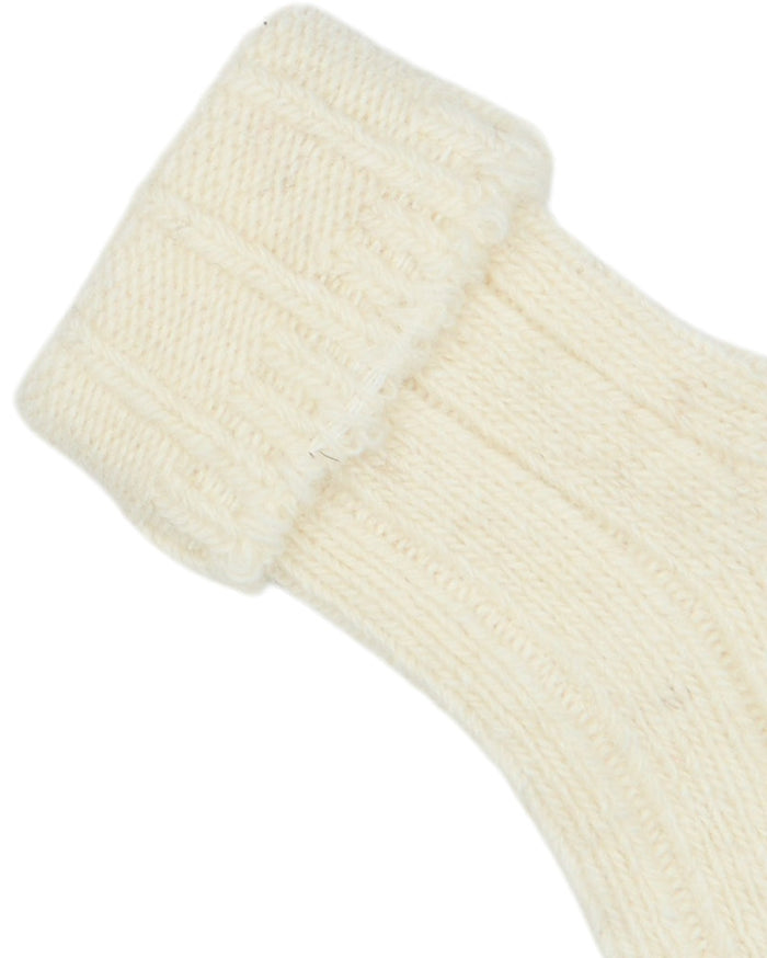 Close-up of a cream-colored sock on a white background