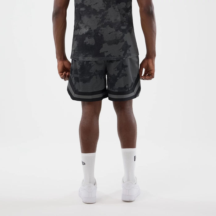 The model is wearing this New Era All Over Print Mesh Shorts in black camo. 2