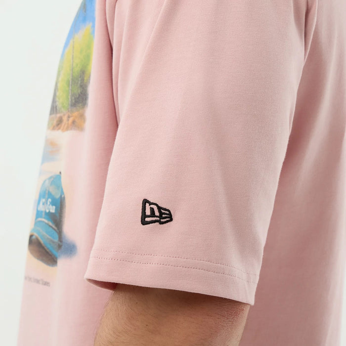 The model is wearing this New Era Beach Graphic Oversized T-Shirt in pastel pink. 7