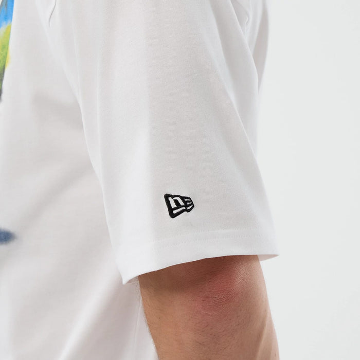 The model is wearing this New Era Beach Graphic Oversized T-Shirt in white. 7