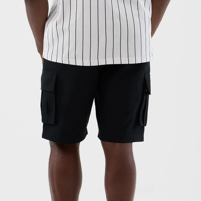 The model is wearing this New Era Cargo Shorts in black. 7