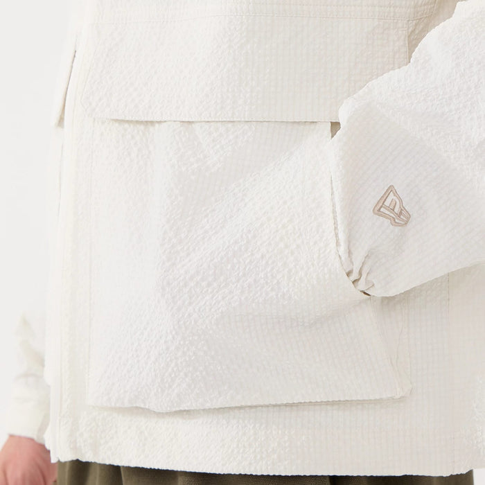 The model is wearing this New Era Black Label Jacket in open white. 5