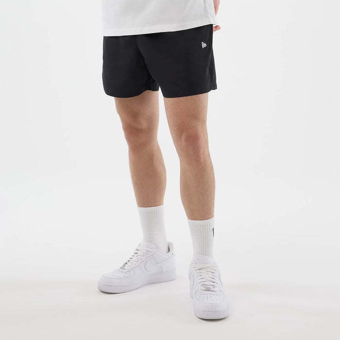 The model is wearing this New Era Swimming Shorts in black. 3