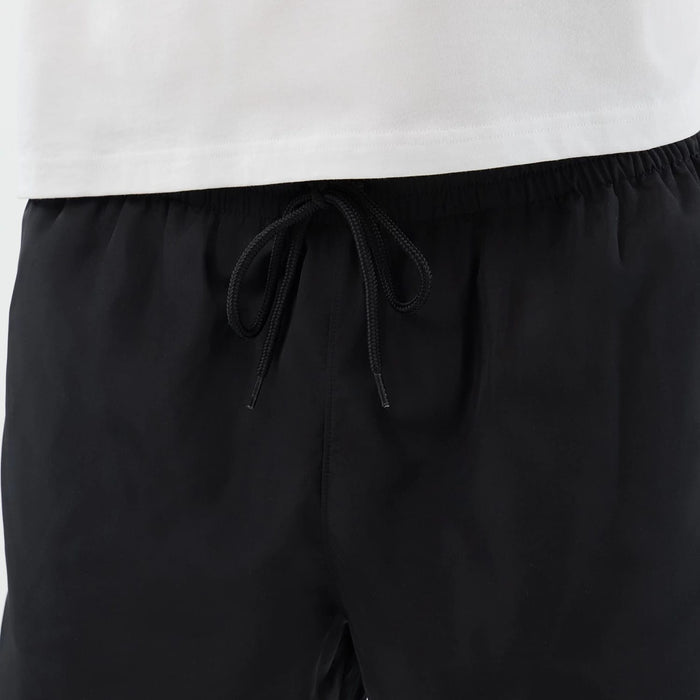 The model is wearing this New Era Swimming Shorts in black. 7