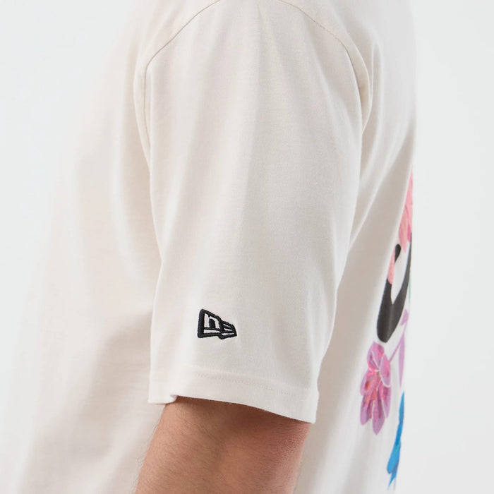 The model is wearing this New Era Floral Graphic Oversized T-Shirt in open white. 5