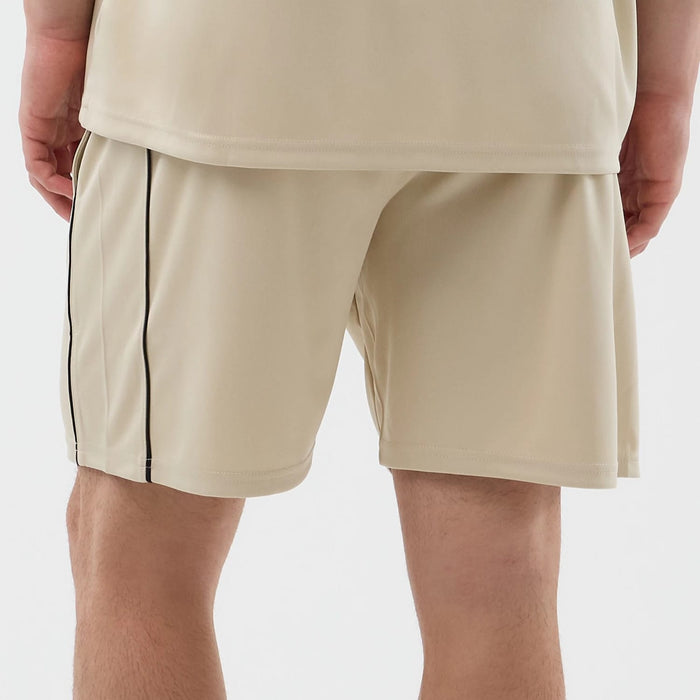 The model is wearing these New Era Football Shorts in light beige. 6