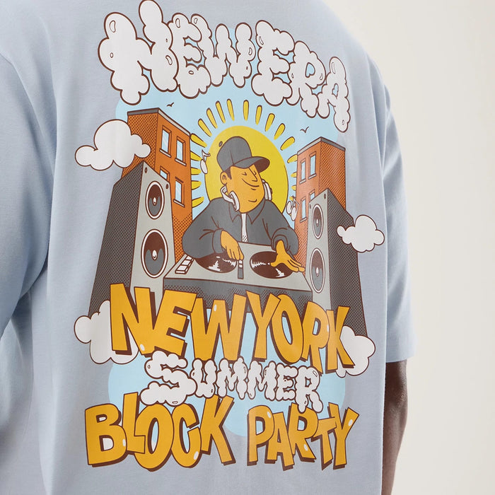 The model is wearing this New Era Fun Block Party Graphic Oversized T-Shirt in pastel blue. 8