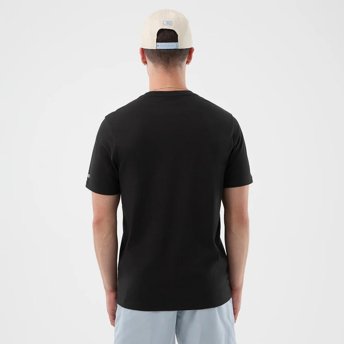 The model is wearing this New Era Logo Graphic T-Shirt in black. 2