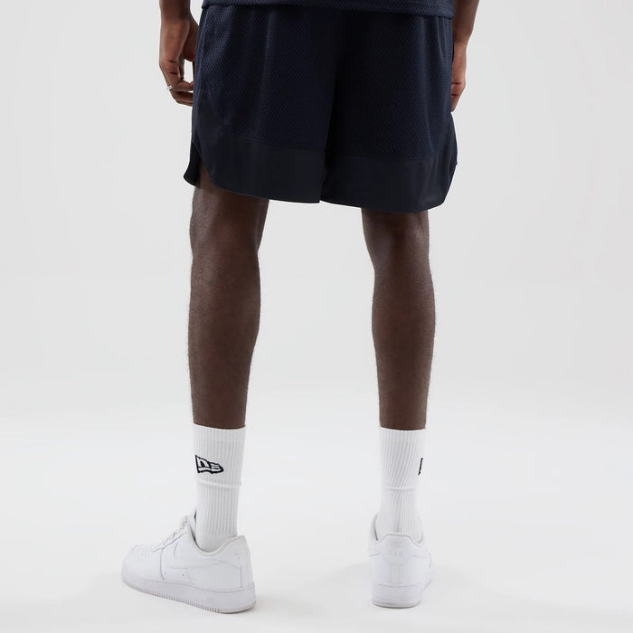 The model is wearing this New Era Mesh Oversized Shorts in navy. 2