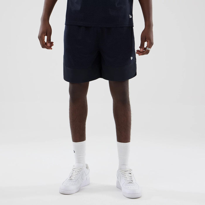 The model is wearing this New Era Mesh Oversized Shorts in navy. 5