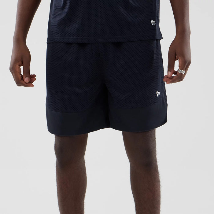 The model is wearing this New Era Mesh Oversized Shorts in navy. 6