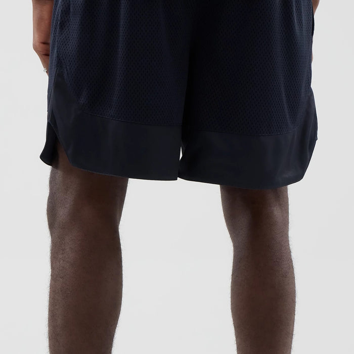The model is wearing this New Era Mesh Oversized Shorts in navy. 7