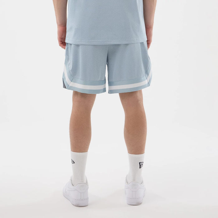 The model is wearing this New Era Mesh Oversized Shorts in pastel blue. 2