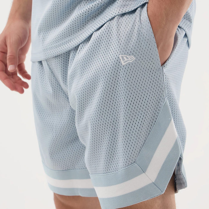 The model is wearing this New Era Mesh Oversized Shorts in pastel blue. 5