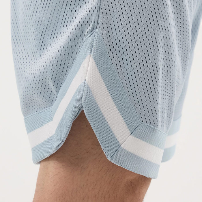The model is wearing this New Era Mesh Oversized Shorts in pastel blue. 6