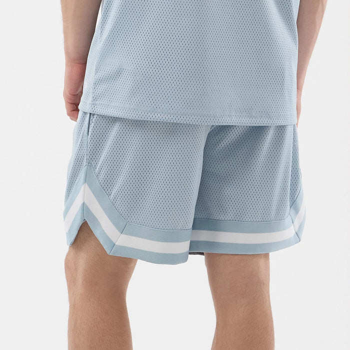 The model is wearing this New Era Mesh Oversized Shorts in pastel blue. 7