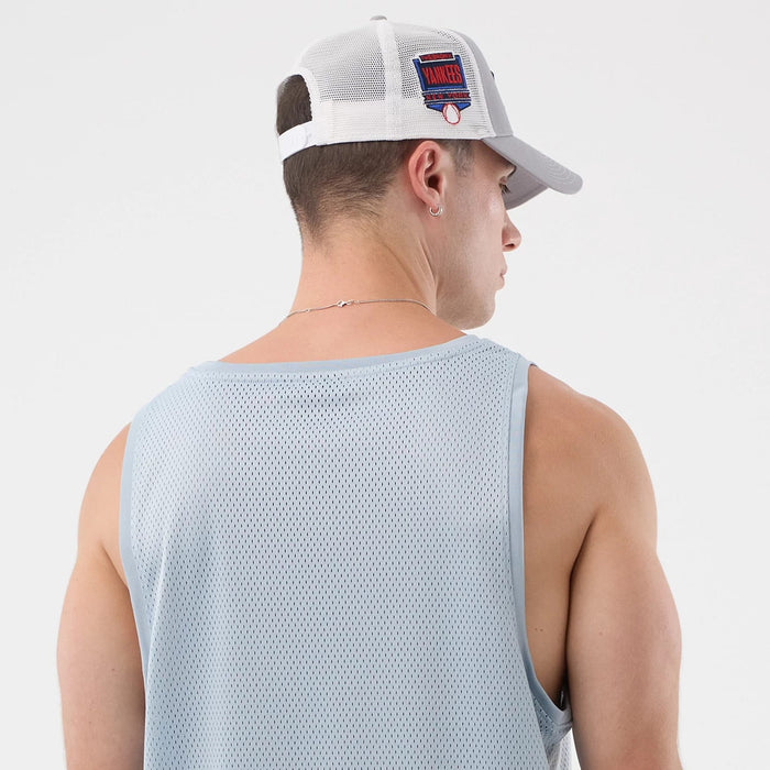 The model is wearing this New Era Mesh Oversized Tank Top in pastel blue. 5