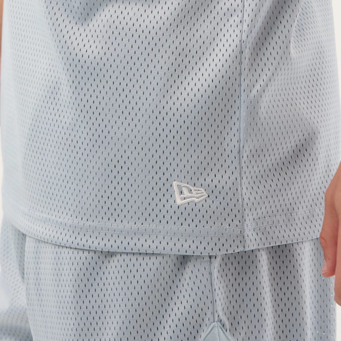 The model is wearing this New Era Mesh Oversized Tank Top in pastel blue. 7