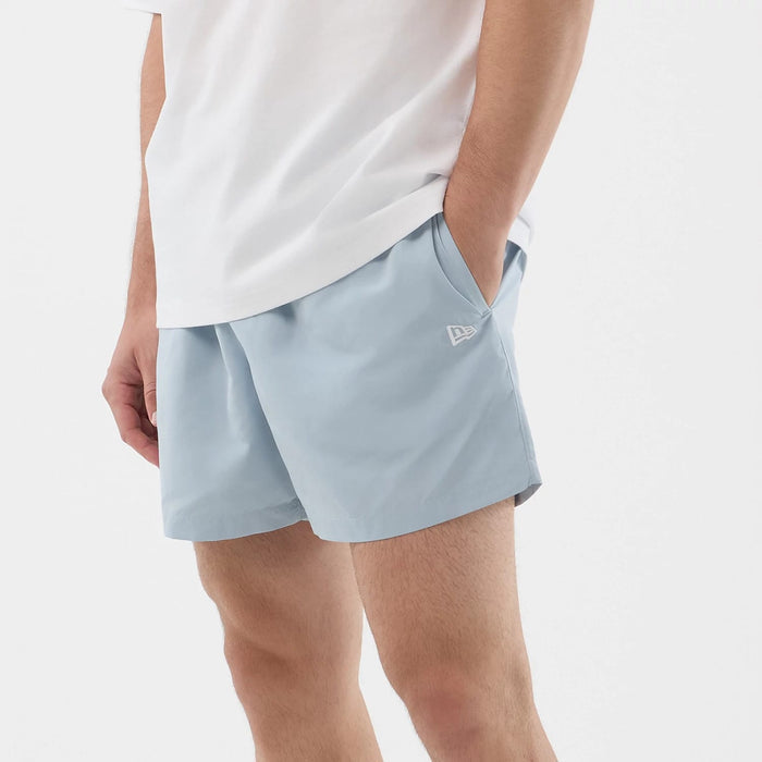 The model is wearing this New Era Swimming Shorts in pastel blue. 5