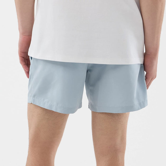 The model is wearing this New Era Swimming Shorts in pastel blue. 6