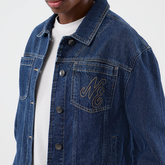 The model is wearing this New Era Script Denim Jacket in dark blue. 5