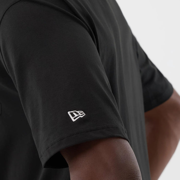 The model is wearing this New Era Serpent Graphic Oversized T-Shirt in black. 5