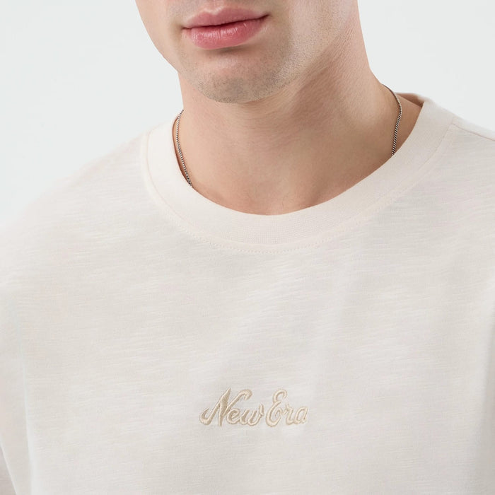 The model is wearing this New Era Slub Oversized T-Shirt in open white. 5