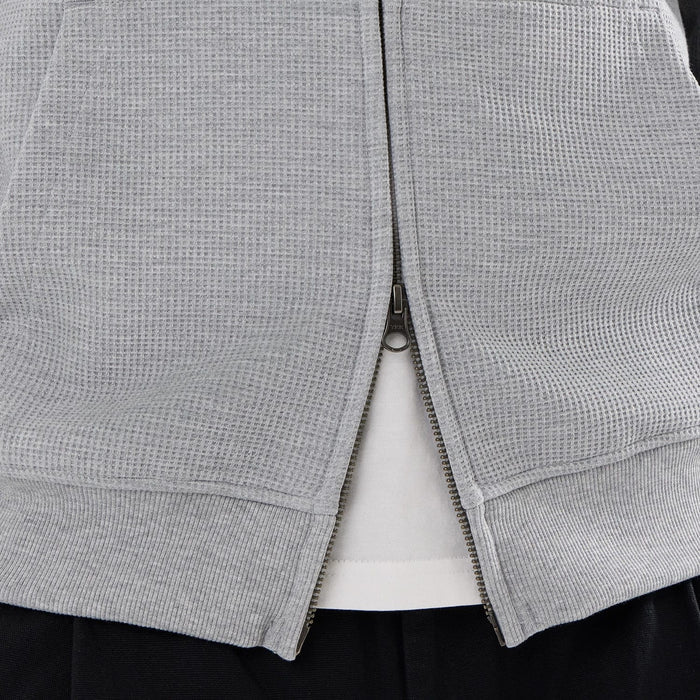 The model is wearing this New Era Waffle Full Zip Hoodie in grey. 6