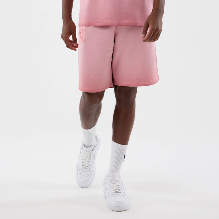 The model is wearing this MLB Washed Logo New York Yankees Shorts in pastel pink. 1