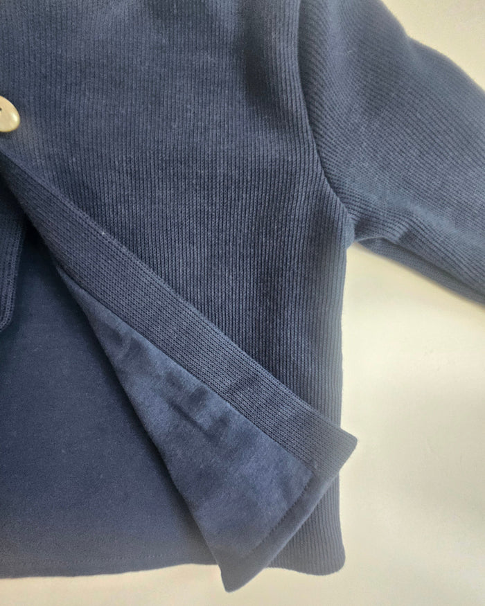 Folded navy blue fabric on a beige background