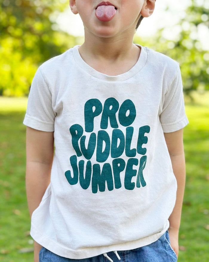 Child wearing a 'Pro Puddle Jumper' t-shirt outdoors