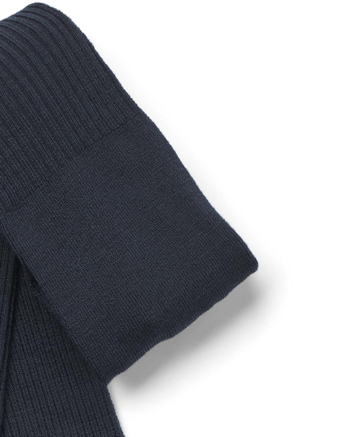 Folded navy blue sock on a white background