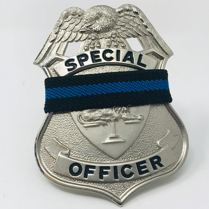 Special Police Officer with thin blue line mourning band Lion on scale